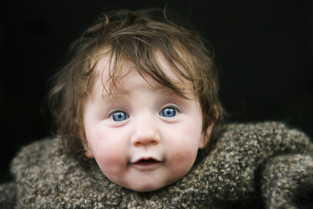 A baby in a warm sweater