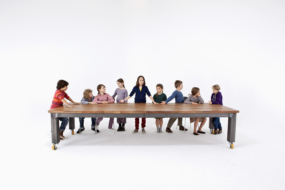Nine kids arranged to imitate Leonardo Da Vinci's The Last Supper