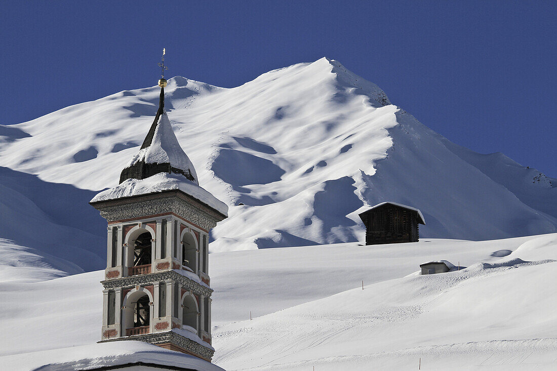 Church tower and snowy mountain in background