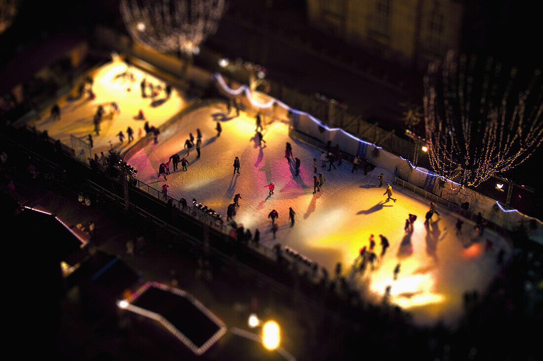 Tilt-shift of skaters on an ice rink at night, Strasbourg, France