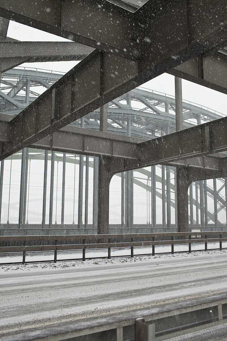 The metal structure of a road bridge in a snowstorm