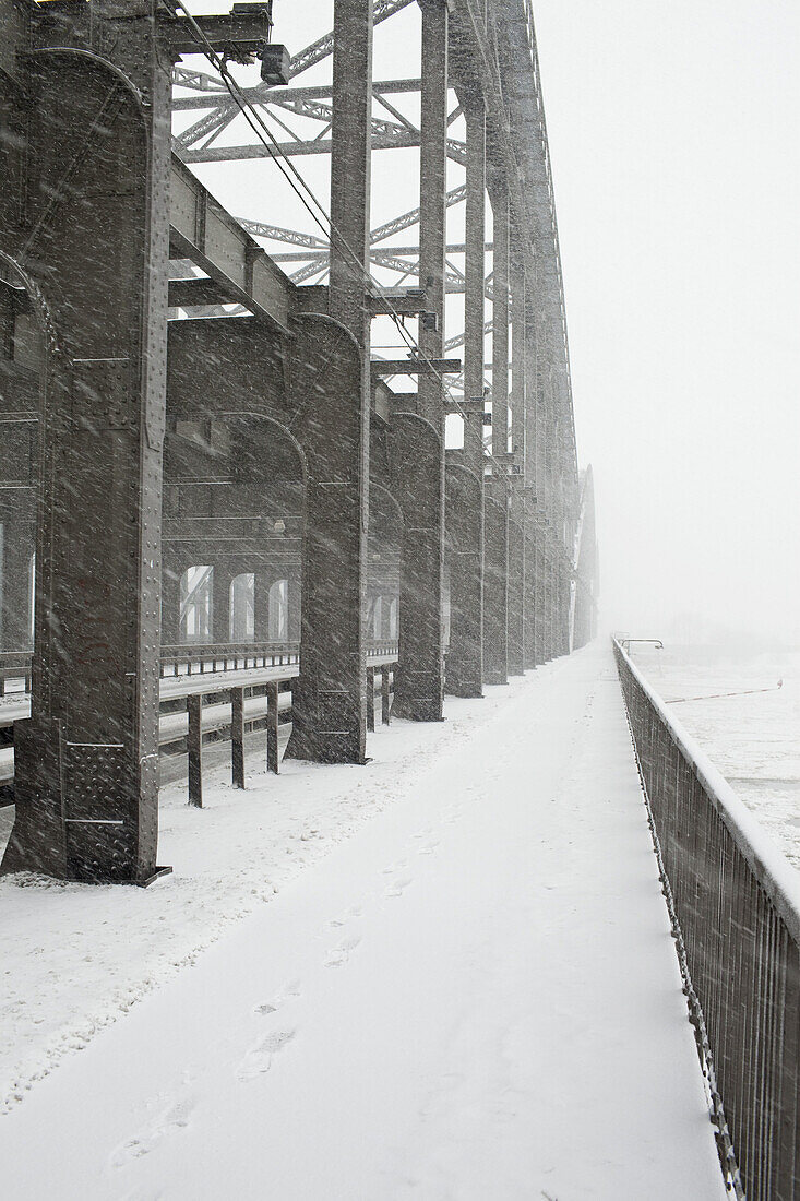 The metal structure of a bridge in a snowstorm