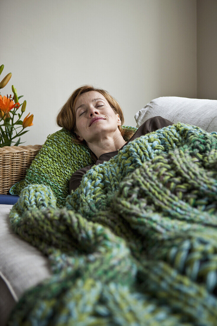 A woman napping on a sofa