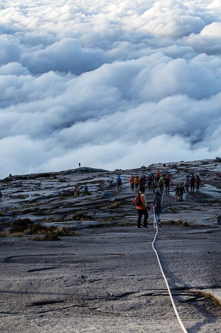 Mountain Tourists climbing down from the Low's Peak 4091 m, Mount Kinabalu, Borneo, Malaysia