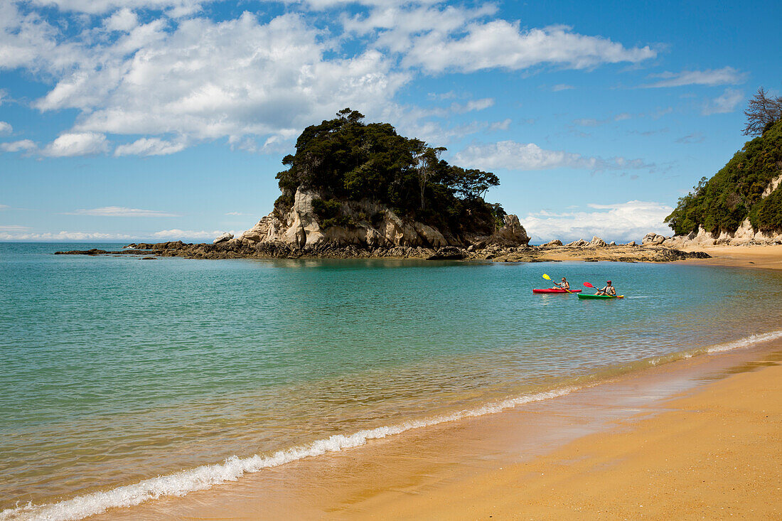 Two kayakers rowing in Tasman Bay near Torlesse Rock at Abel Tasman National Park, near Kaiteriteri, Tasman Region, South Island, New Zealand