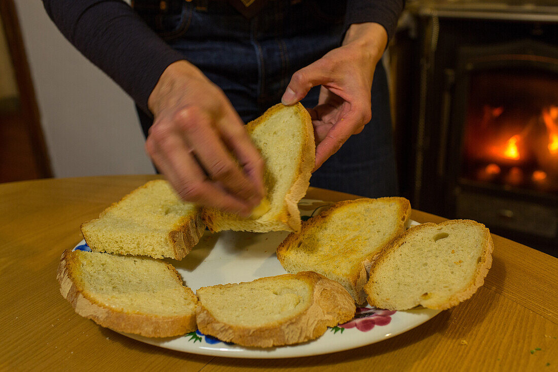 freshly toasted white bread being rubbed with garlic, Tuscany, Italy