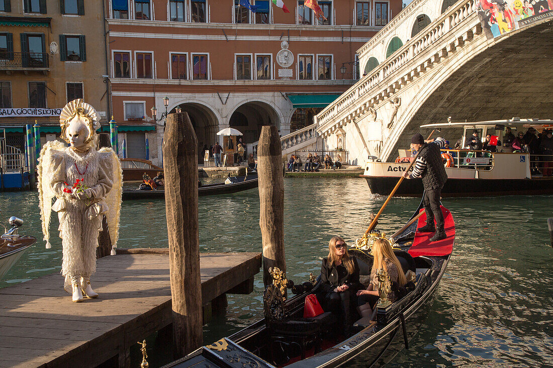 Venetian Carnival, tourism, masks, fantasy, angel, bird, wings, costume, posing, Rialto Bridge, Venice, Italy