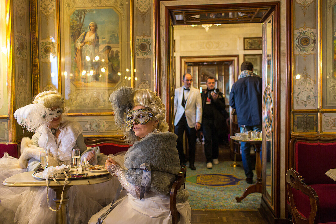 Carnival Venice, Caffè Florian, masked ladies in carnival dress, old traditional coffee house, Piazza San Marco, Venice, Italy