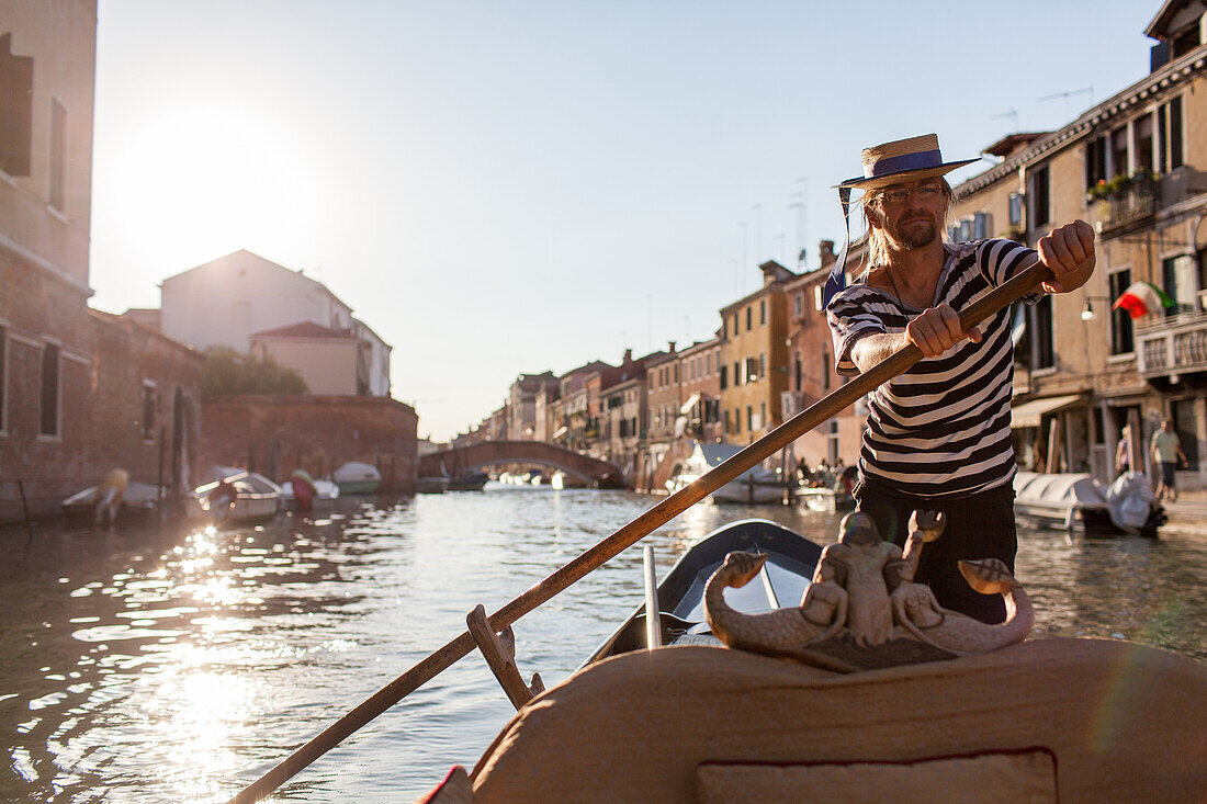 gondolier Kuba, rowing on a canal in Cannaregio, tourist ride, tourism, Venice, Veneto, Italy