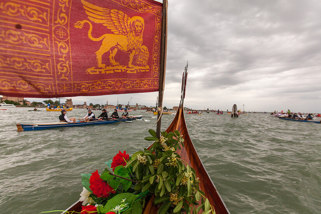 Vogalonga, view from traditional rowing boat with Venetian Serenissima flag, red flag with lion of San Marco, motorboat free day, festival, Venice, Veneto, Italy