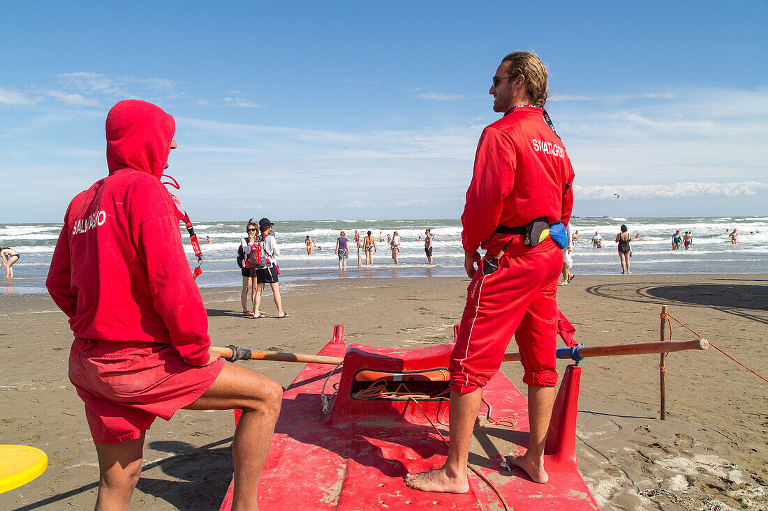 popular sandy swimming beach, life guards in red,  Lido, Adriartic Sea, Venice, Italy