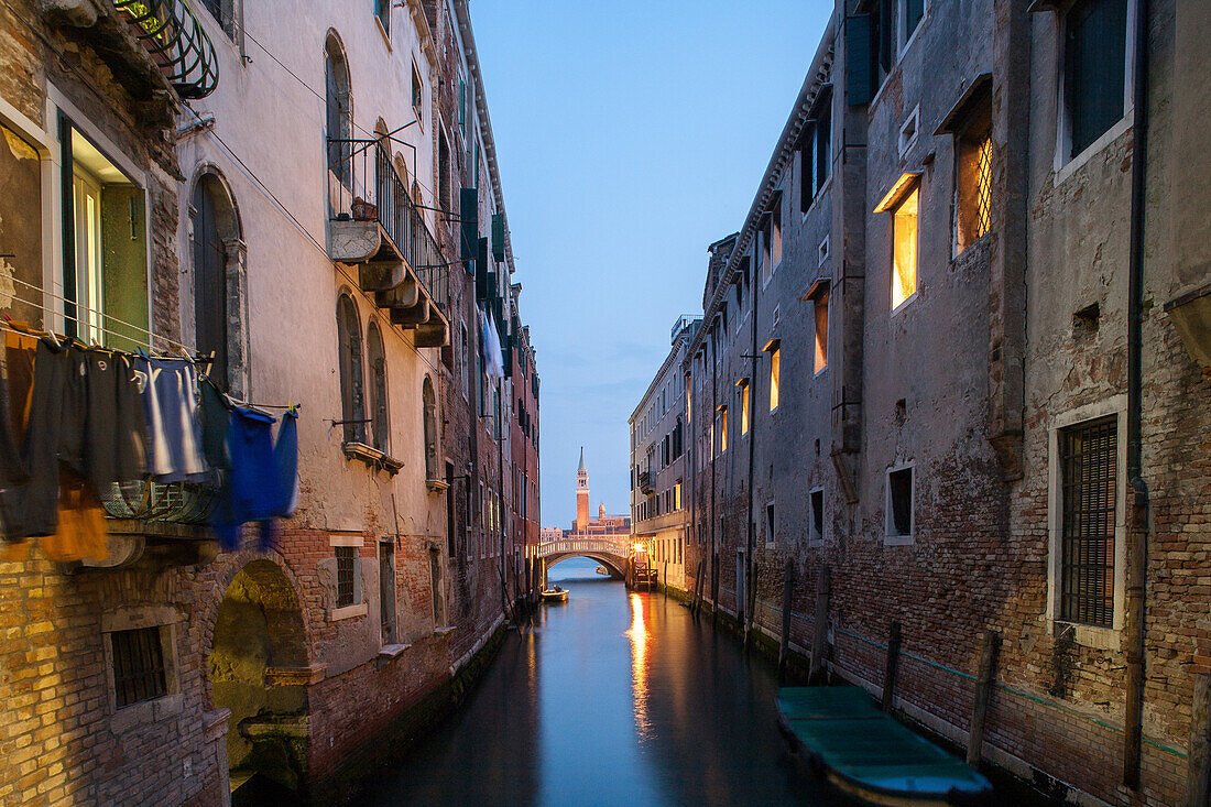 night view down a narrow canal, reflections, Canal Rio de la Pieta, Campanile San Giorgio Maggiore, old walls, lagoon, washing, still, Venice, Italy