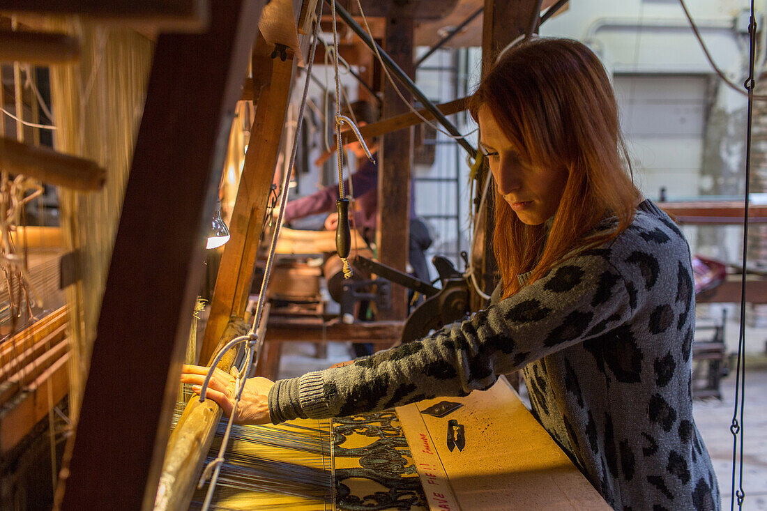 Tessitura Luigi Bevilacqua, weaving textiles, traditional, handcraft, brocades on historic looms, here the weaver Gloria d'Este, Venice, Italy