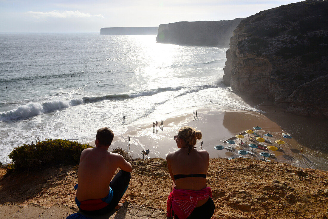 Young couple admiring the view, Surfer beach near Sagres, Algarve, Portugal