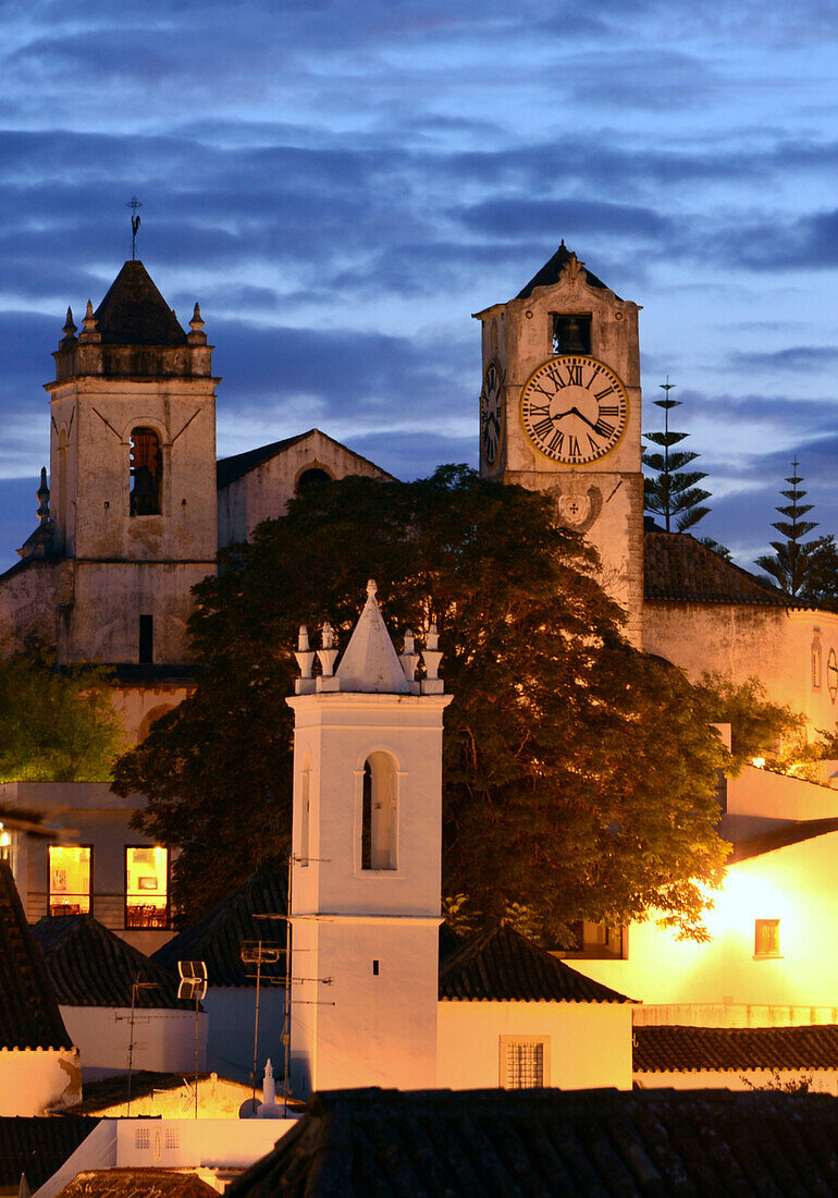 View over the old town to Castel and Santa Maria at night, Tavira, Algarve, Portugal