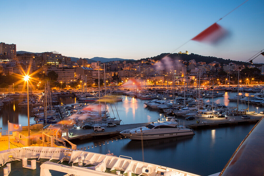 Bow of cruise ship MS Deutschland (Reederei Peter Deilmann) and sailing boats in the marina at dusk, Palma, Mallorca, Balearic Islands, Spain