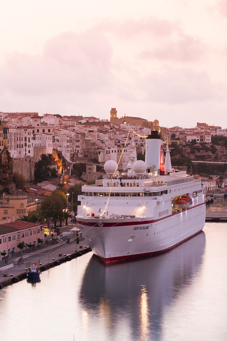 Cruise ship MS Deutschland (Reederei Peter Deilmann) at pier and old town buildings at sunset, Mahon, Menorca, Balearic Islands, Spain