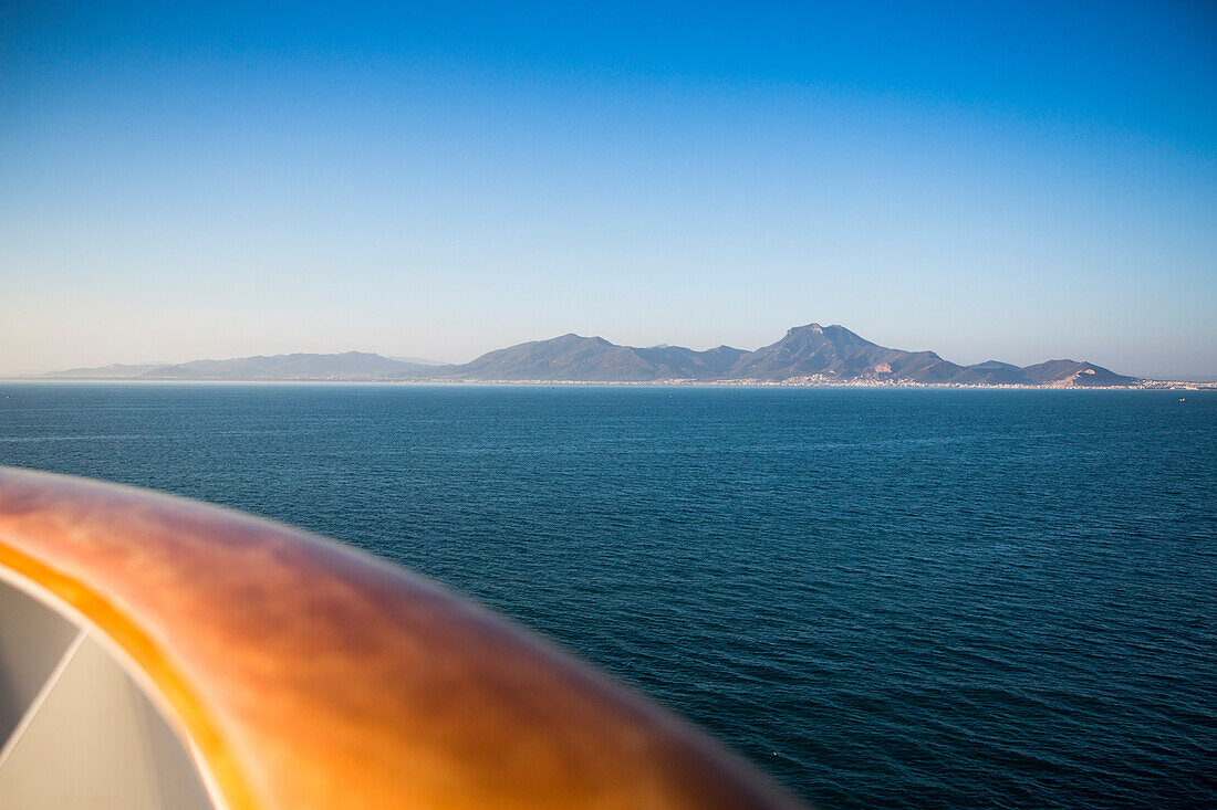 Railing of cruise ship MS Deutschland (Reederei Peter Deilmann) and Tunisian coastline, near La Goulette, Tunis, Tunisia