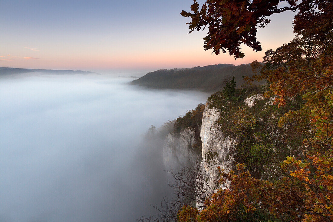 View from Eichsfelsen over the mist in the valley of the Danube river, Upper Danube Nature Park, Baden- Wuerttemberg, Germany