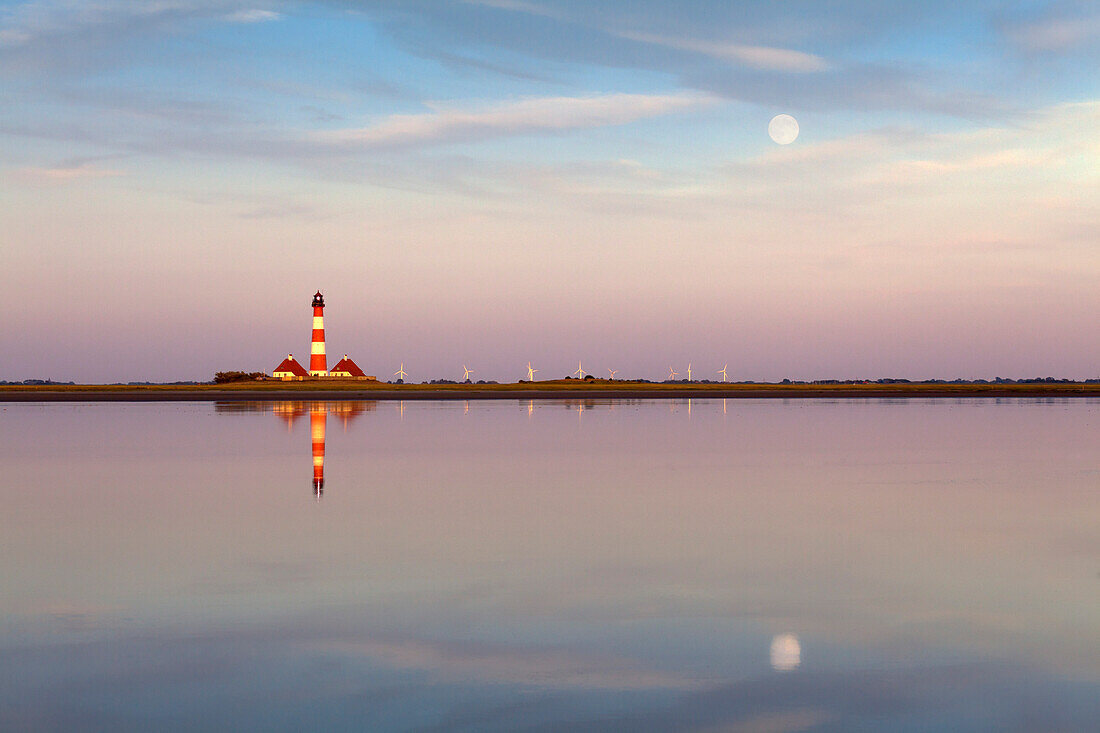 Lighthouse and moon reflecting in the flats near Westerhever lighthouse, Eiderstedt peninsula, Schleswig-Holstein, Germany