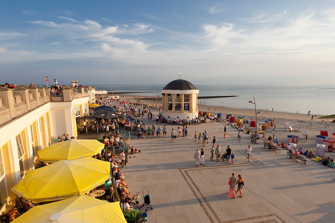 People sitting in a cafe on the beach promenade, Pavilion in the background, Borkum, Ostfriesland, Lower Saxony, Germany