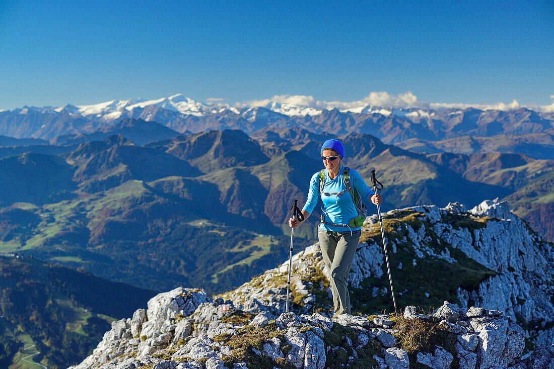 Woman hiking on ridge with Grossvenediger in the background, Nurracher Hoehenweg, Ulrichshorn, Loferer Steinberge range, Tyrol, Austria