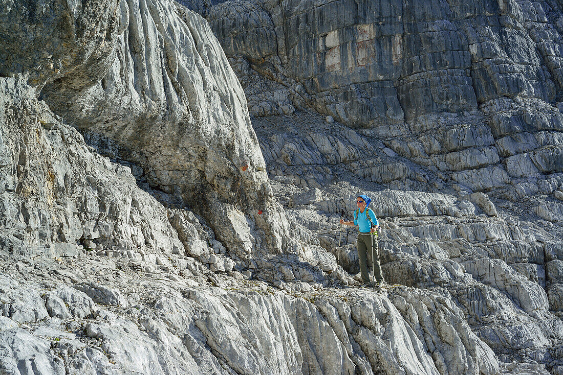 Woman hiking on karst formation, Nurracher Hoehenweg, Loferer Steinberge range, Tyrol, Austria
