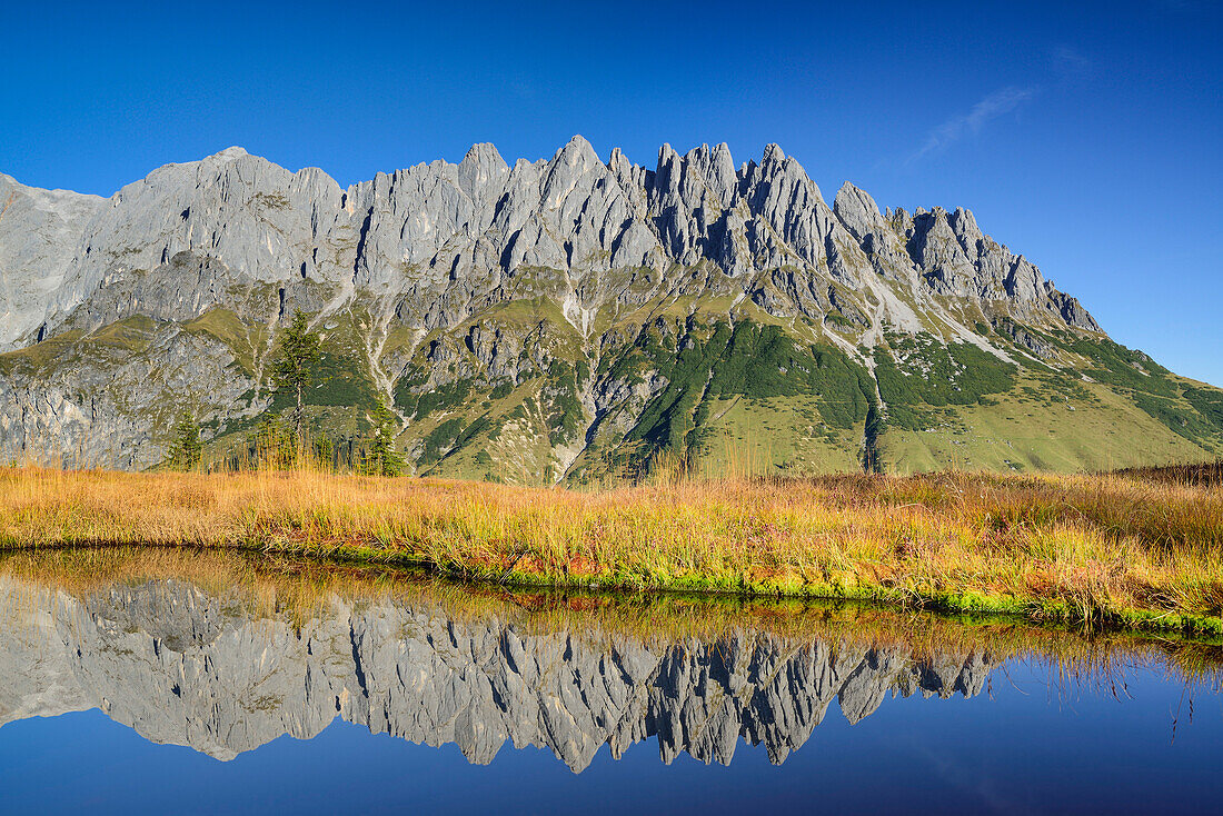 Mandlwand ridge at Hochkoenig and reflections in mountain lake, Berchtesgaden range, Salzburg, Austria