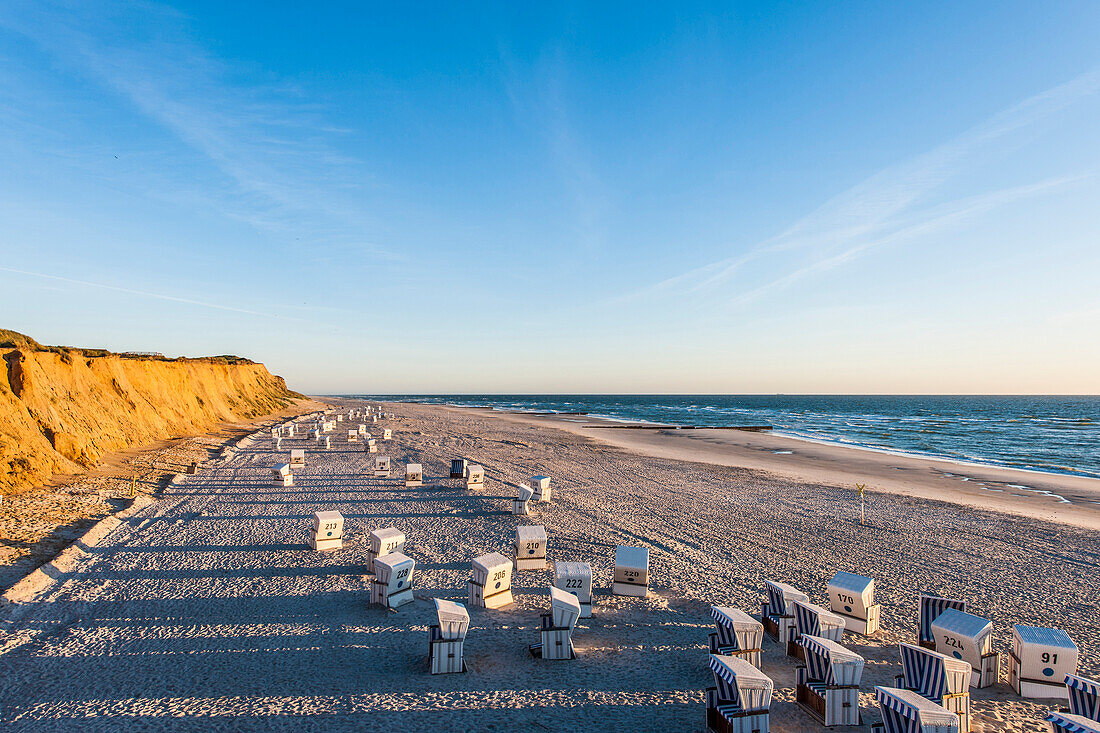 Roofed wicker beach chairs at beach, Rotes Kliff, Kampen, Sylt, Schleswig-Holstein, Germany