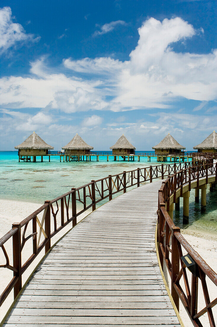 French Polynesia, Tuamotu Islands, Rangiroa Atoll, Boardwalk Leading To Luxury Resort Bungalows Over Ocean.