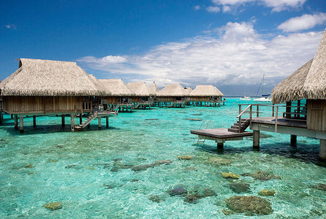 French Polynesia, Moorea, Luxury Resort Bungalows Over Ocean.