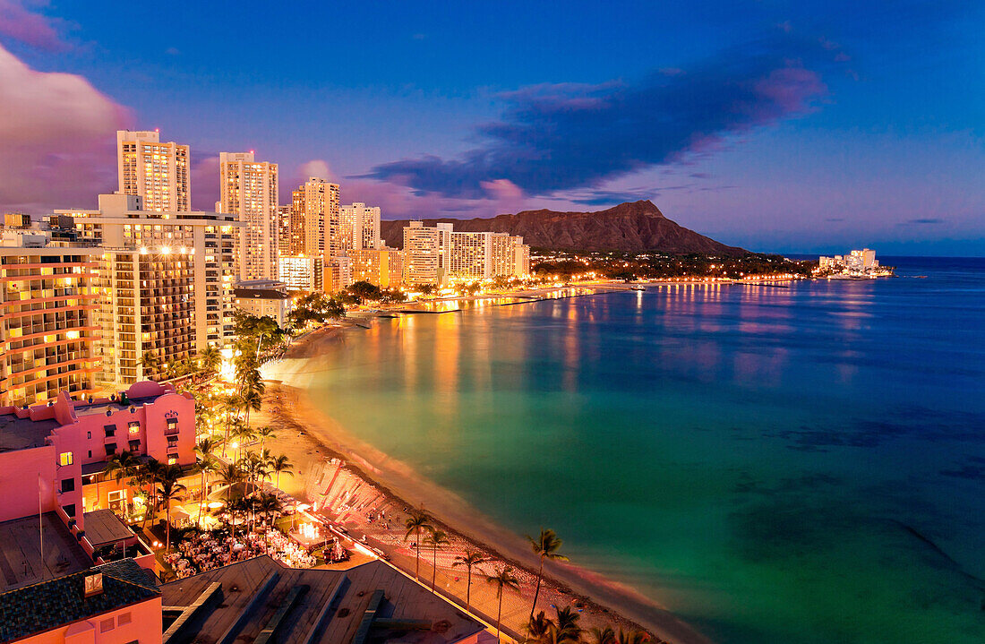 Hawaii, Oahu, Waikiki, View Of Hotels Along Ocean And Diamond Head In The Evening.