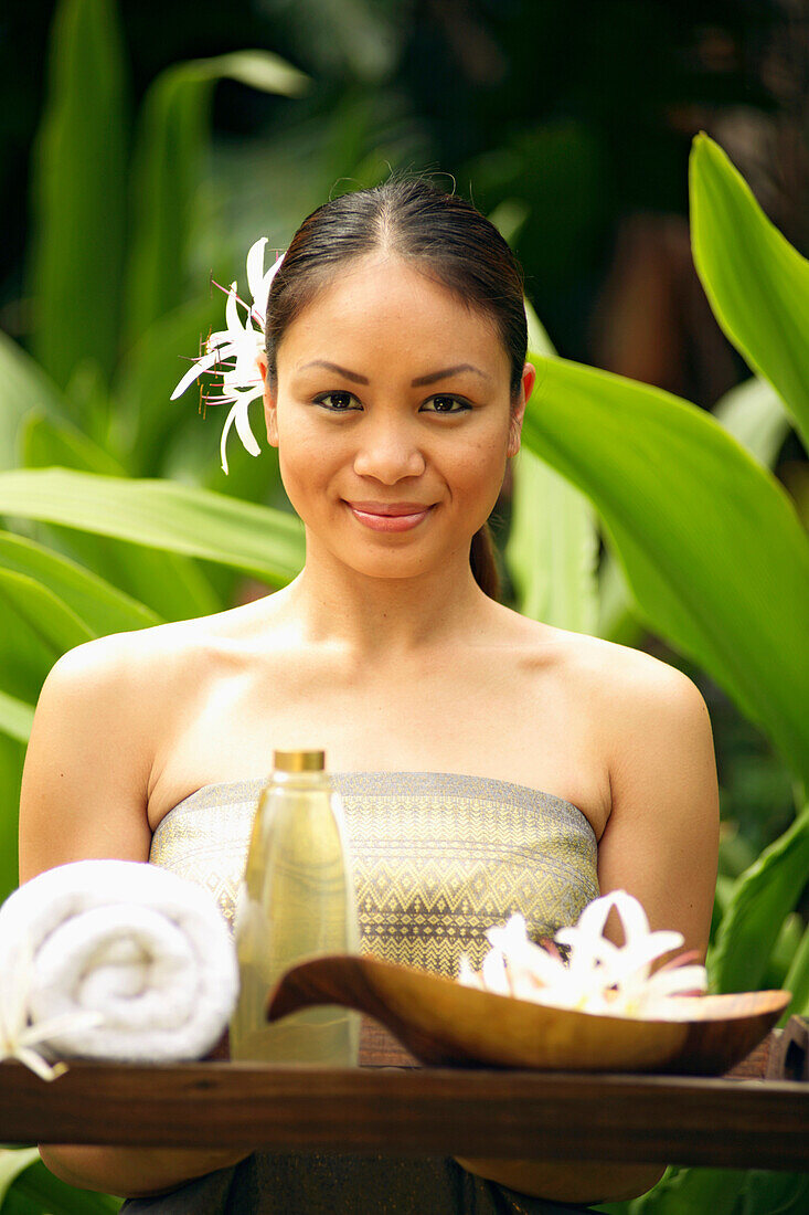 Beautiful Polynesian Woman At A Spa Holding A Tray Of Spa Implements.
