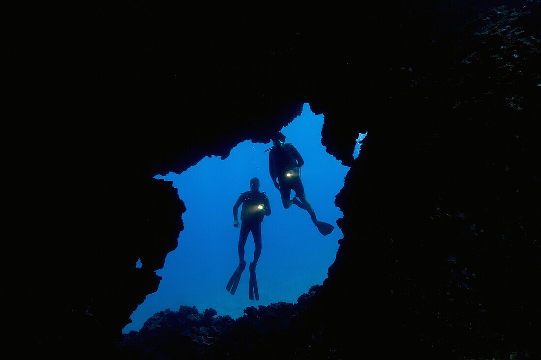 Hawaii, Lanai, Two Divers With Flashlights, Pictured At Entrance To An Underwater Lava Tube.