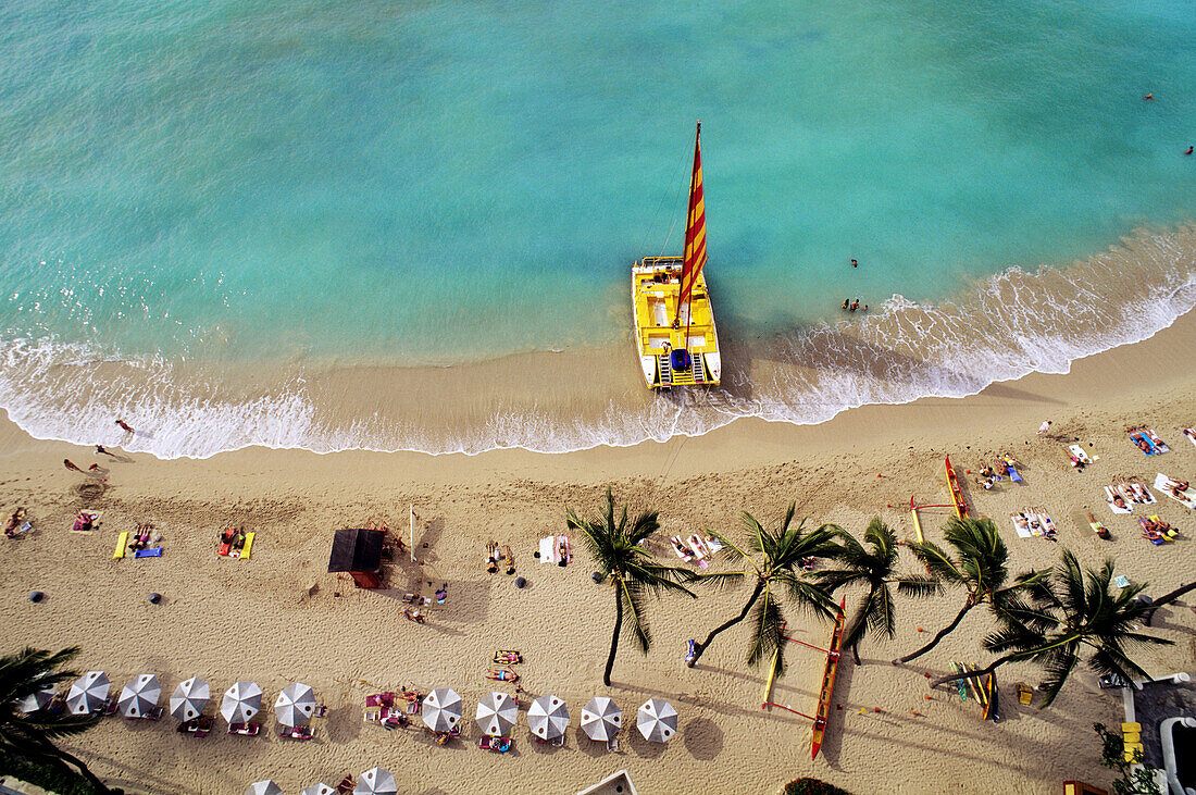 Hawaii, Oahu, Waikiki Beach With Catamaran, Umbrellas And Vacationers On Beach, View From Above