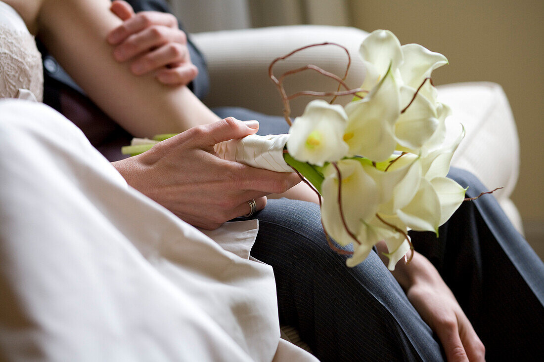 Groom And Bride Holding Bouquet