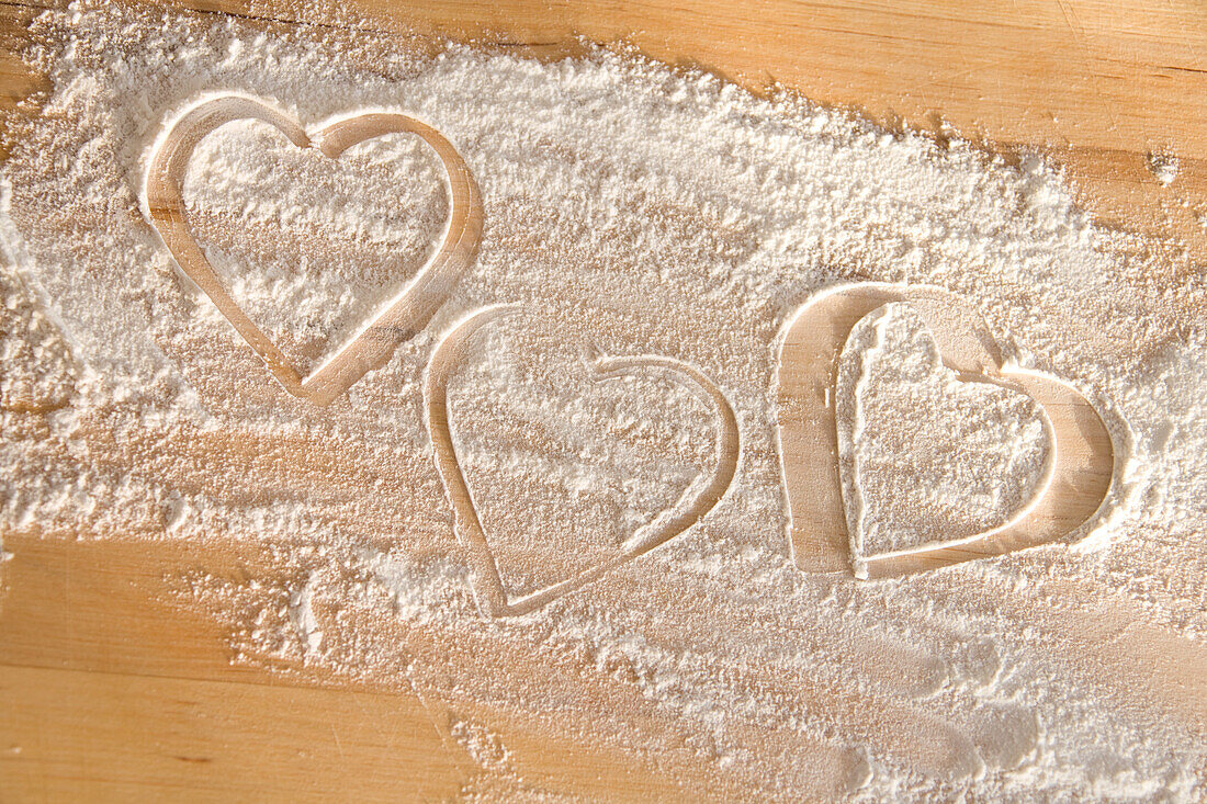 Hearts Drawn In Flour On Wooden Table Top