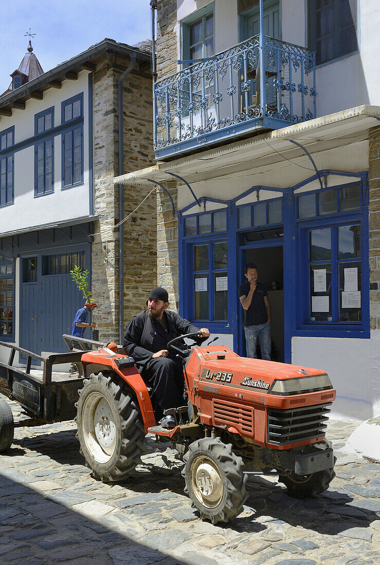 Greece, Chalkidiki, Mount Athos peninsula, listed as World Heritage, Orthodox monk driving a tractor in the streets of Karyes, the small capital of Mount Athos.