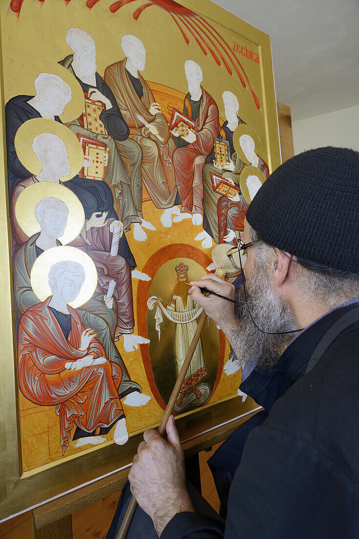 Greece, Chalkidiki, Mount Athos peninsula, World Heritage Site, Skete Prodromos (Timiou Prodromou), Monk painting an icon of the Pentecost.