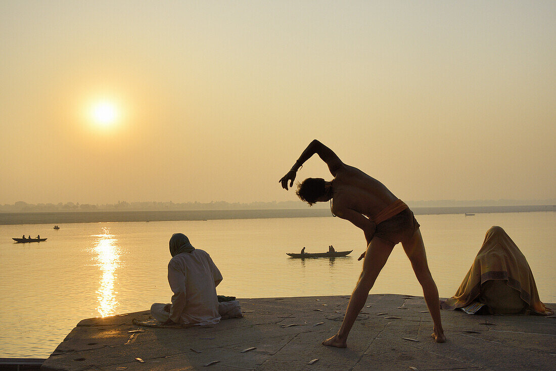 India, Uttar Pradesh, Varanasi, Yogi practising at sunrise.