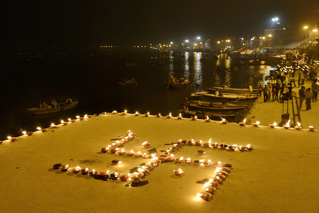 India, Uttar Pradesh, Varanasi, Swastika shaped earthen lamps lit for Dev Deepawali festival.