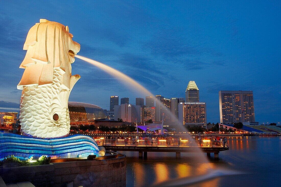 Merlion statue with Esplanade and Suntec City skyscrapers at the background, Singapore.