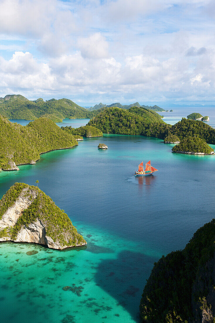 'Tiger Blue Phinisi schooner sailing through Pulau Wayag Islands of Raja Ampat; Indonesia'