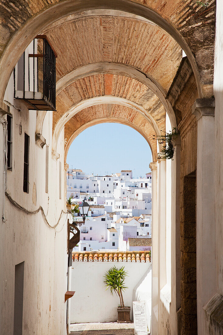 'View of whitewashed buildings from an arched corridor; Veyer de la Frontera, Andalucia, Spain'