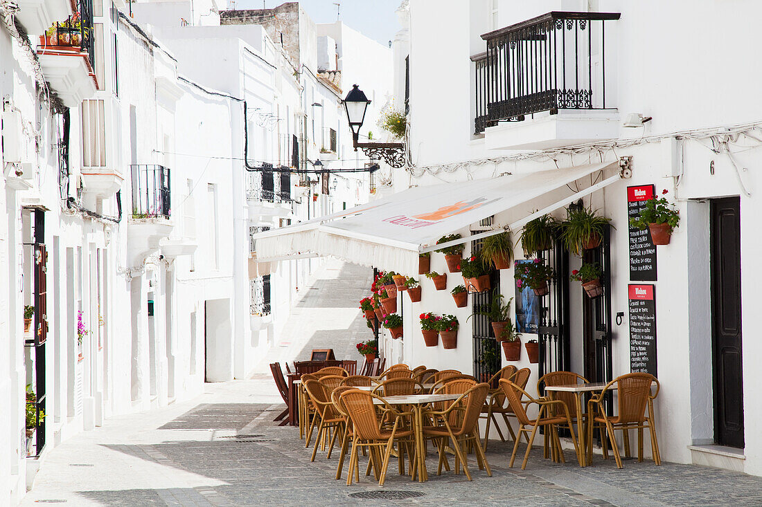 'An outdoor restaurant patio and whitewash buildings; Vejer de la Frontera, Andalusia, Spain'