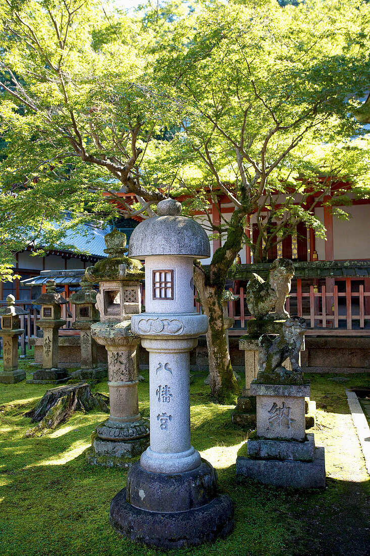 'Buddhist structures on the grass in front of a building; Japan'