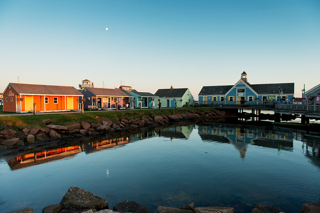'Spinnakers Landing reflected in tranquil water at sunset; Summerside, Prince Edward Island, Canada'