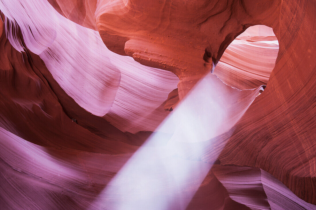 'Light falls through arch in slot canyon formation near Page; Arizona, United States of America'