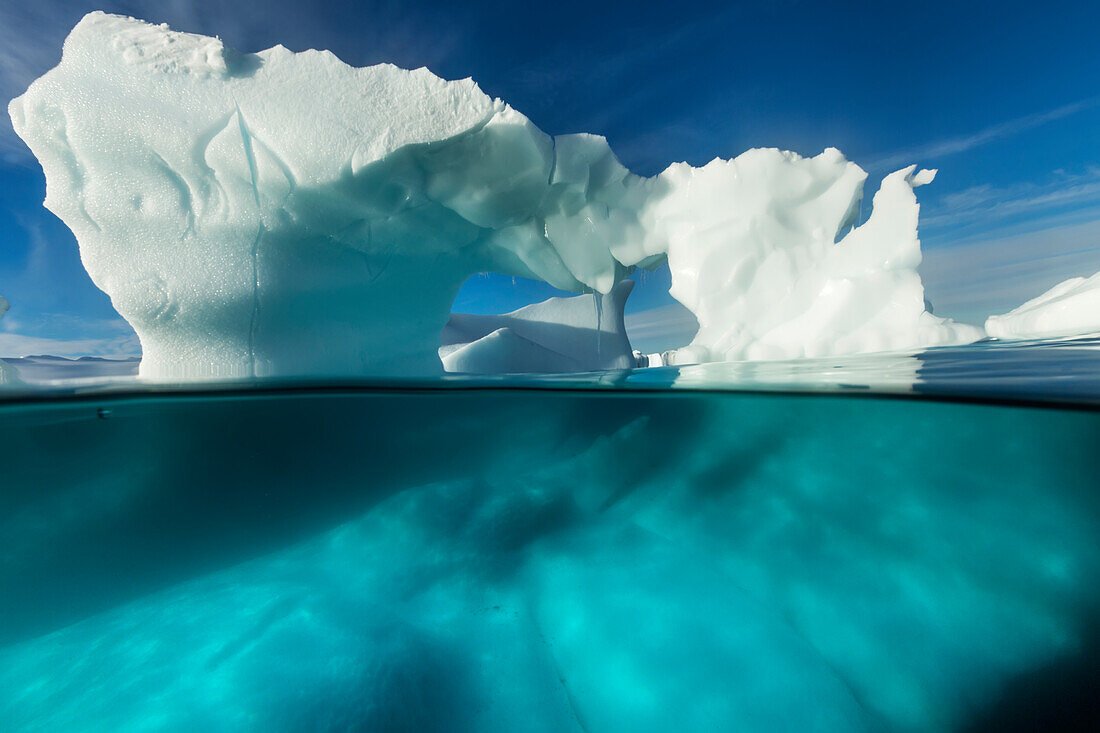 Antarctica, Underwater view of arched Iceberg floating near Enterprise Island on sunny spring morning along Antarctic Peninsula