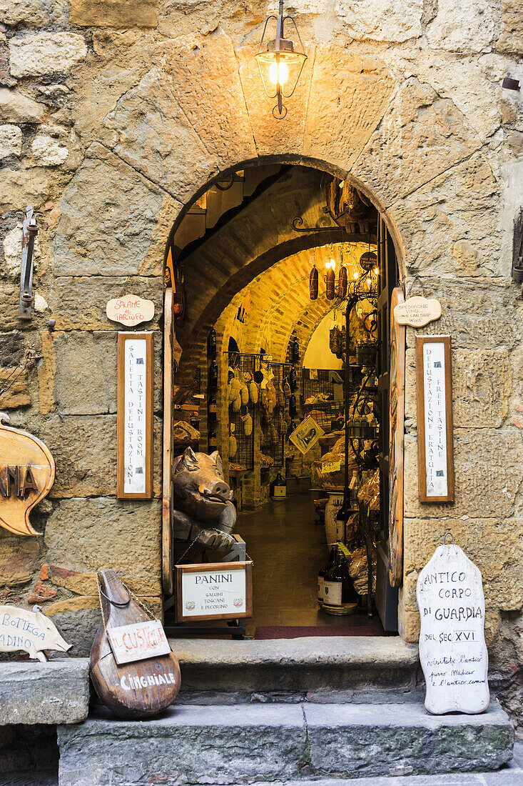 'A retail store with an open arched doorway; Montepulciano, Tuscany, Italy'